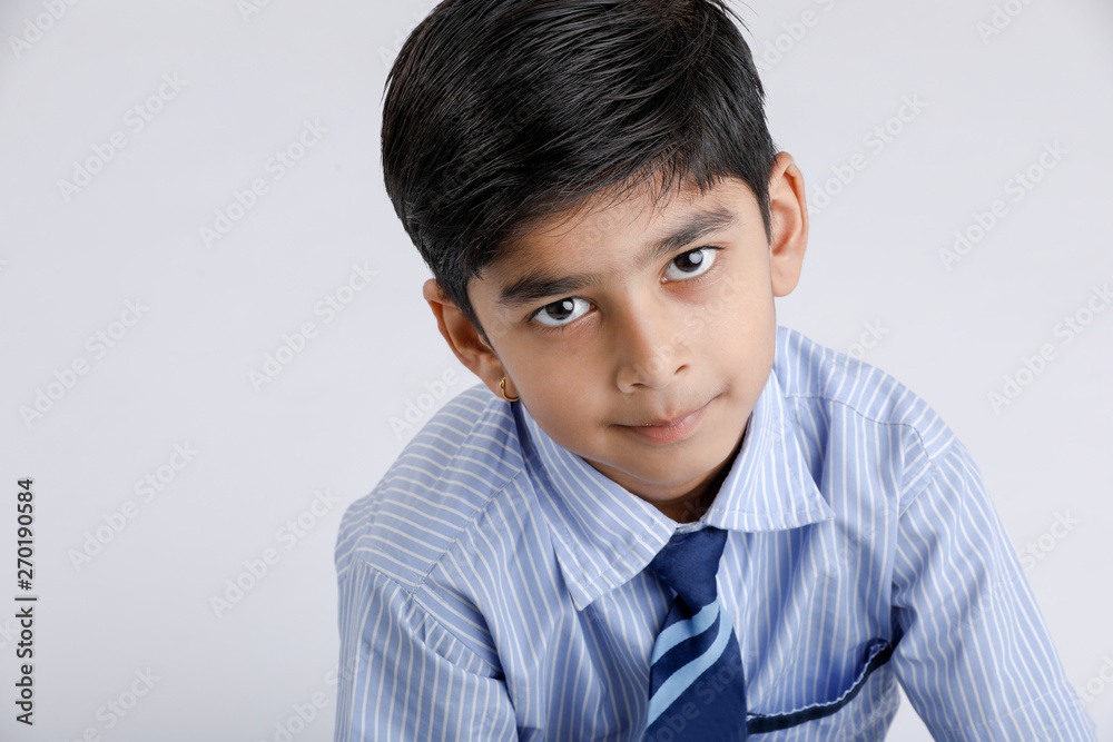 Cute little indian Indian / Asian school boy wearing uniform Cute little indian Indian / Asian school boy wearing uniform
