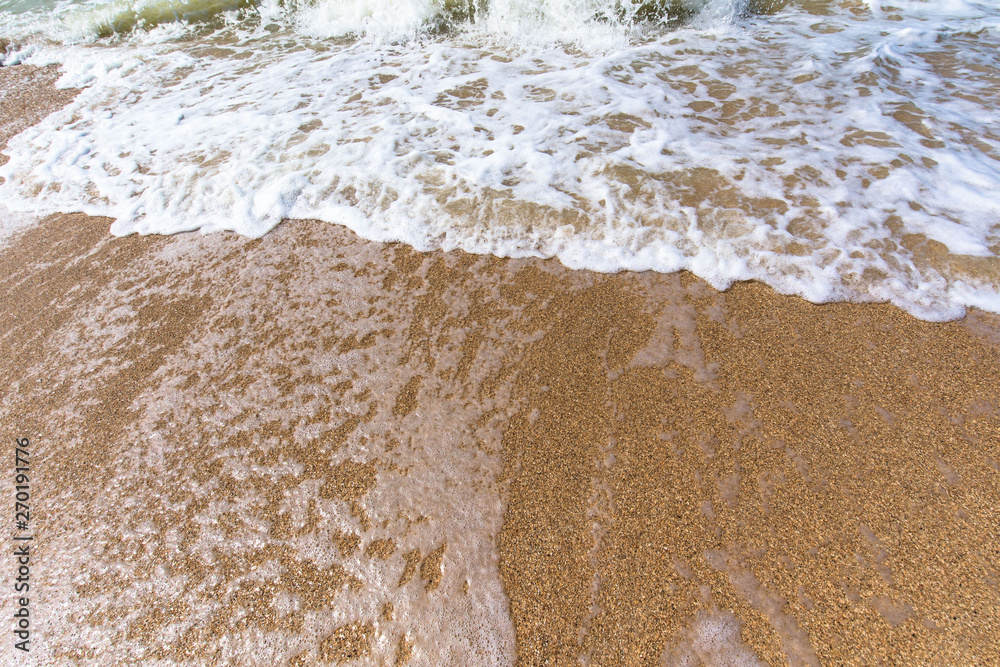 sea wave foam sand gold color. close up