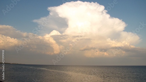 clouds after a thunderstorm over the sea at sunset