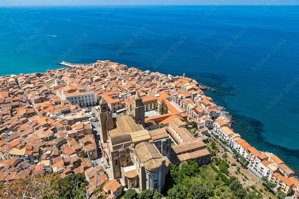 Aerial view of Cefalu old town, Sicily, Italy. It is one of the major tourist attractions in Sicily. Picturesque view from Rocca di Cefalu. Cefalu Cathedral (Duomo di Cefalu) on the foreground