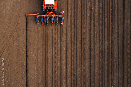 Aerial view of tractor with mounted seeder performing direct seeding photo