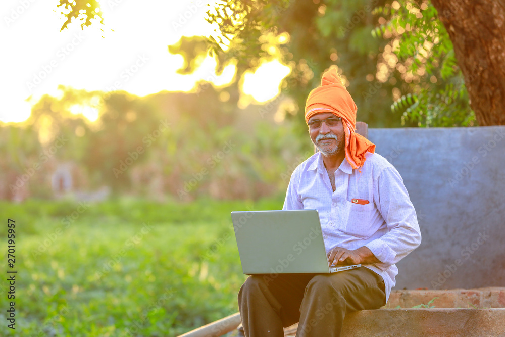 Indian rural farmer using laptop Indian rural farmer using laptop