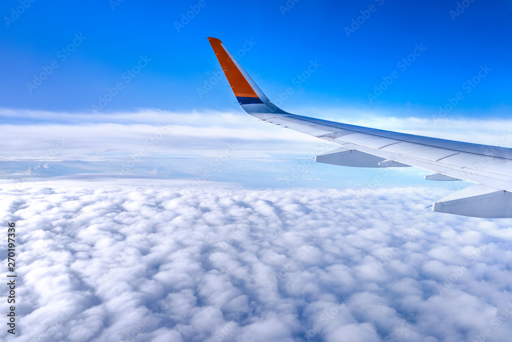 Bussiness and travel concept. Aerial view through window inside aircraft cabin with beautiful blue sky and cloud with sunlight, copy space, top view Bussiness and travel concept. Aerial view through window inside aircraft cabin with beautiful blue sky and cloud with sunlight, copy space, top view