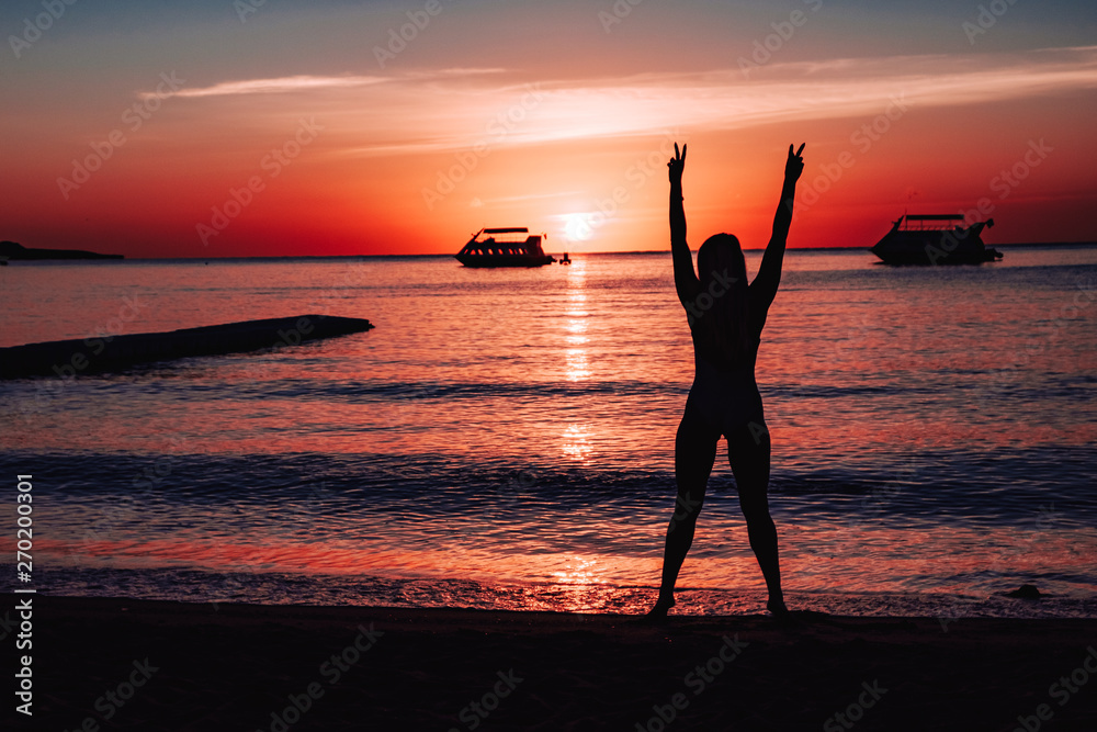 girl silhouette on the seashore.
