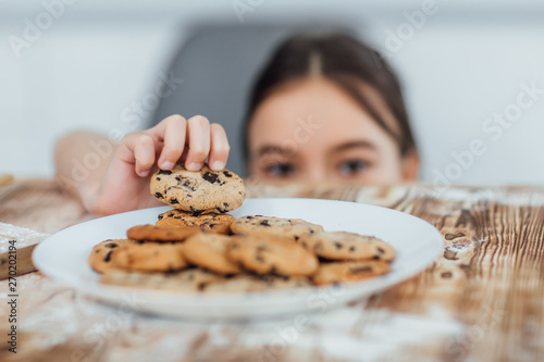 Quadro em tela Focus at small girl steals cookie! Home! Bakery!