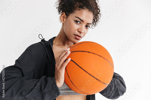 Beautful young amazing sports fitness african woman posing with basketball. © Drobot Dean