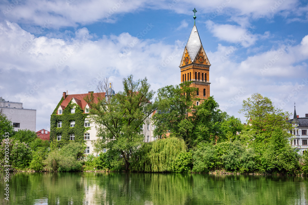 Christ Church reflecting in Isar river Landshut Old Town Bavaria Germany