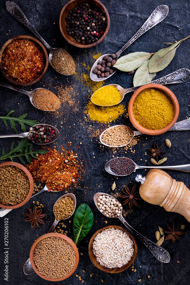 Spices and herbs on black background, top view. Indian cuisine. Spices and herbs on black background, top view. Indian cuisine.