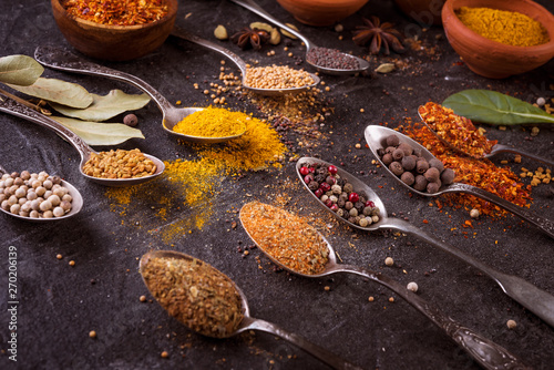 Spices and herbs on black background.  Indian cuisine.
