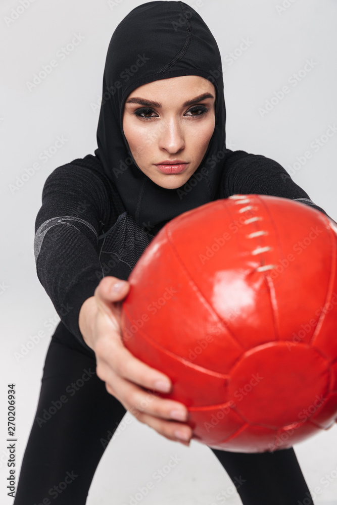 Woman fitness muslim make exercises with ball isolated over white wall background. Woman fitness muslim make exercises with ball isolated over white wall background.