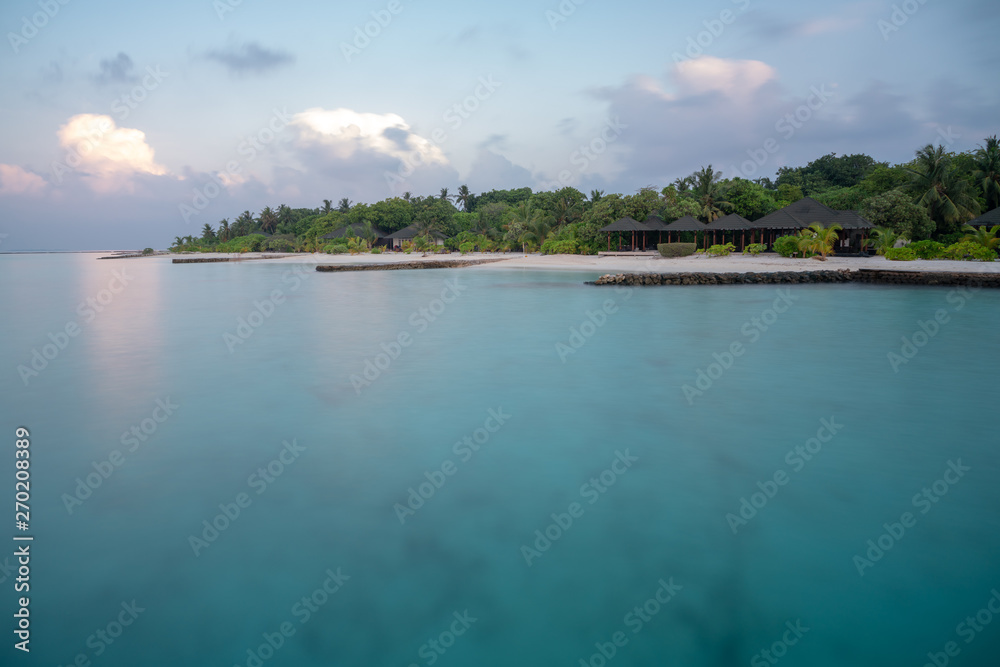 long time exposure of the maledivian beach with palmes and villas long time exposure of the maledivian beach with palmes and villas