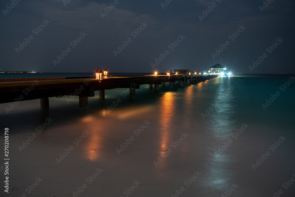 Obraz premium dock at night with various colored lights