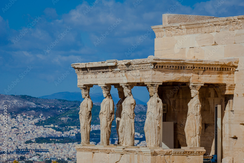 Lateral view of the Loggia of the Caryatids with town background, Athens