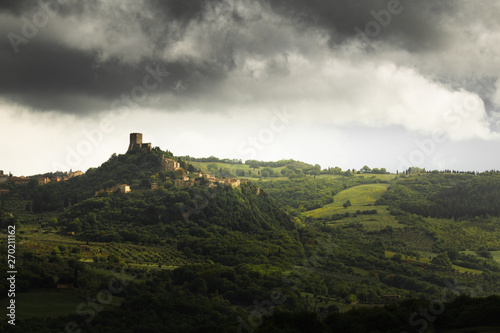 Dramatic light and rainy clouds over the town Castiglione D'Orcia in Tuscany, Italy