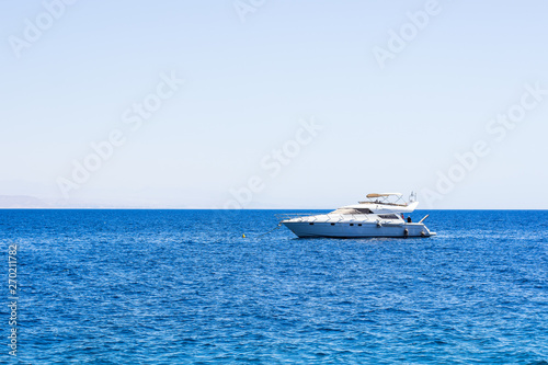 cruise summer vacation concept photography of lonely white speed boat on Red sea calm water surface with horizon line background south scenery landscape simple wallpaper pattern with empty copy space © Артём Князь