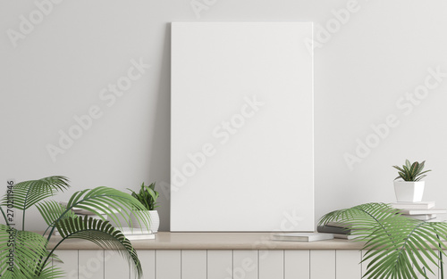 Fotografia, Obraz Mock-up of picture canvas frame with small plant in vase and books on white wall