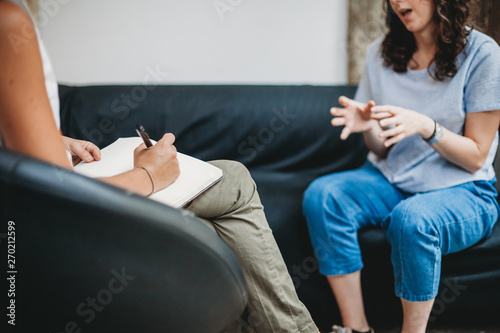 Psychotherapy session, woman talking to his psychologist in the studio