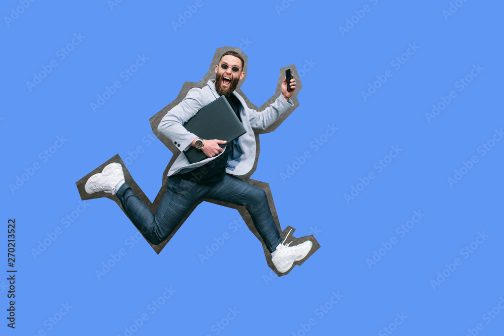 Positive handsome young businessman running in the air along an empty wall. Crazy emotions. Positive handsome young businessman running in the air along an empty wall. Crazy emotions.