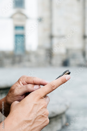 man using his smartphone on the street.