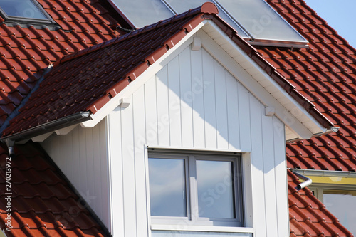 Tiled roof with wooden cladded dormer