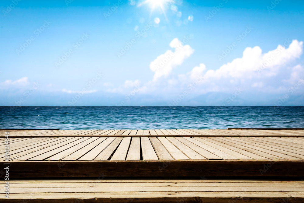 Fototapeta premium Summer wooden pier of free space for your deoration and ocean landscape with sun light. 