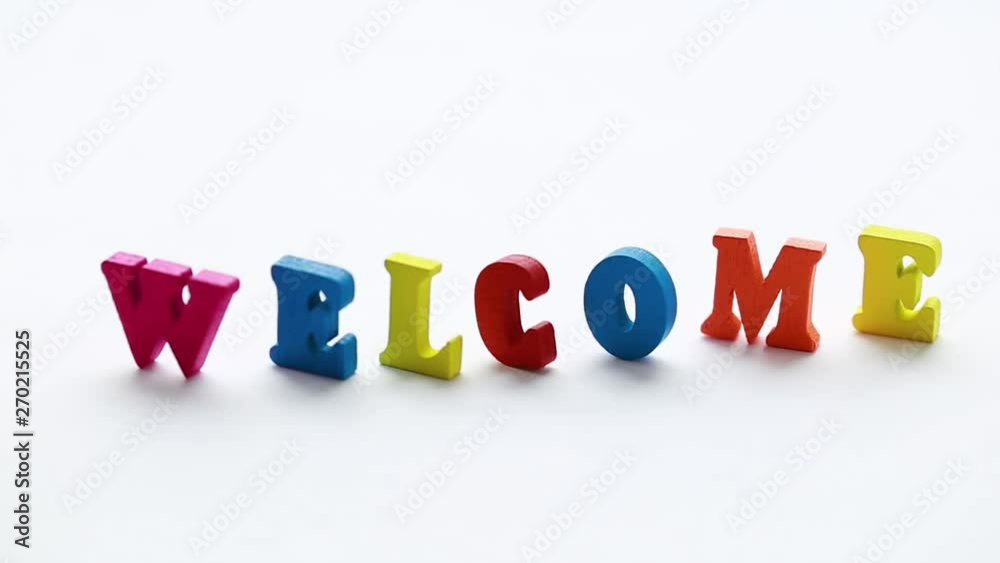 The invitation consists of colored wooden letters standing on a white background. Letters go to the focus The invitation consists of colored wooden letters standing on a white background. Letters go to the focus