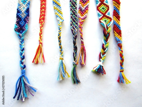 friendship bracelets made of thread with braids on white background	