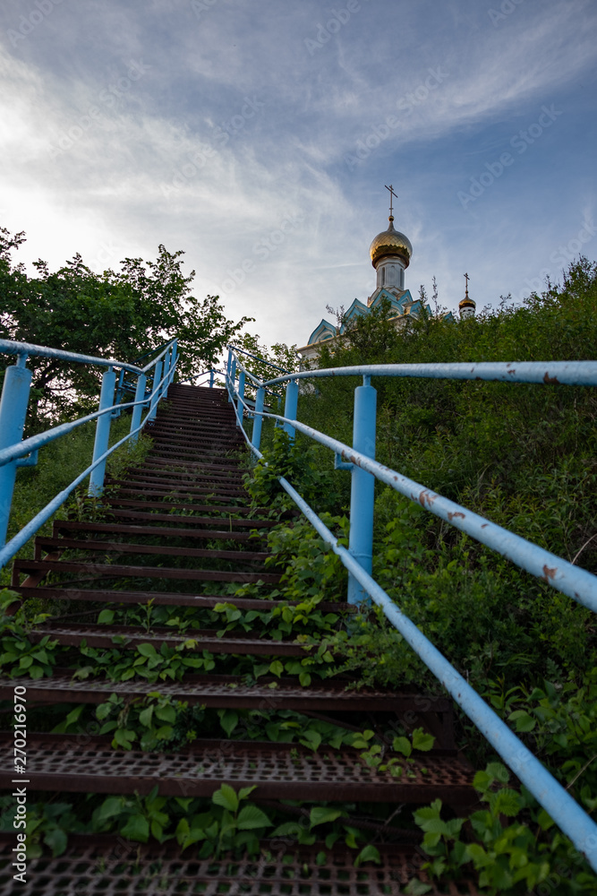blue metal staircase with steps leading to the temple which stands on the mountain blue metal staircase with steps leading to the temple which stands on the mountain