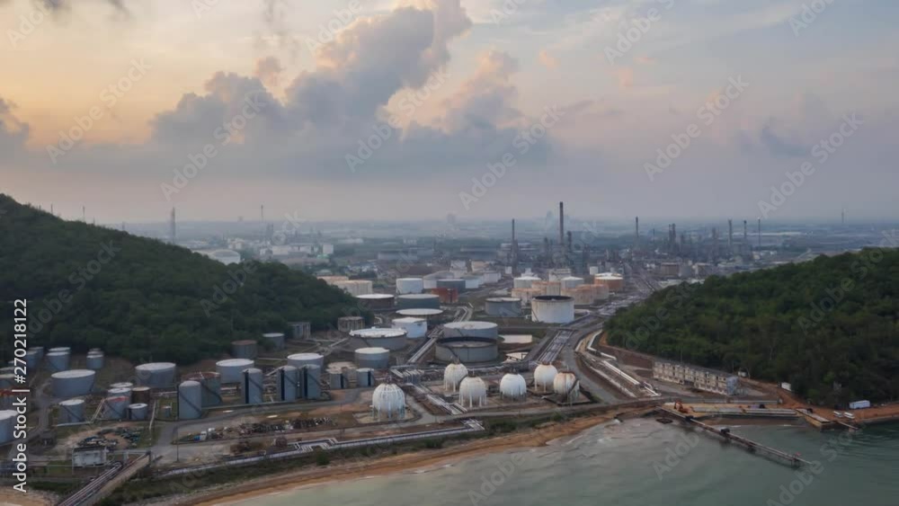 Aerial Time Lapse. Oil refinery factory and oil storage tank at sunrise. Petrochemical Industrial. Aerial Time Lapse. Oil refinery factory and oil storage tank at sunrise. Petrochemical Industrial.