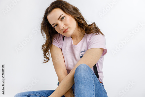 Young beautiful girl posing on white background. Emotions and gestures.