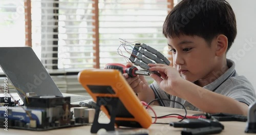 Wallpaper Mural Boy try to fixing computer board in school science club. Project for engineering club in school. People with technology concept. Torontodigital.ca