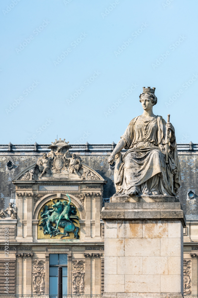Statue 'La Ville de Paris' at the Pont du Carrousel with Louvre museum in the background, Paris, France