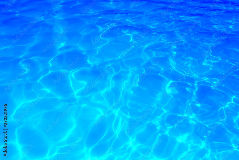 Obraz premium Blue color water in swimming pool rippled water detail background.