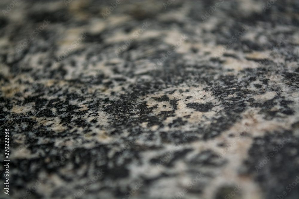 Background or texture from a gray stone with round spots and stains. Natural material. Glossy surface. Background or texture from a gray stone with round spots and stains. Natural material. Glossy surface.