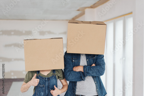 Couple doing DIY renovations wearing boxes