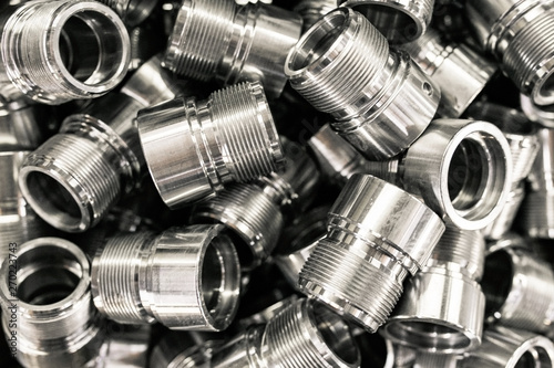 A pile of metal parts, CNC machine blanks. Pile of many CNC turning engineering parts