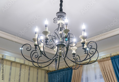 luxurious black metal chandelier hanging on the ceiling