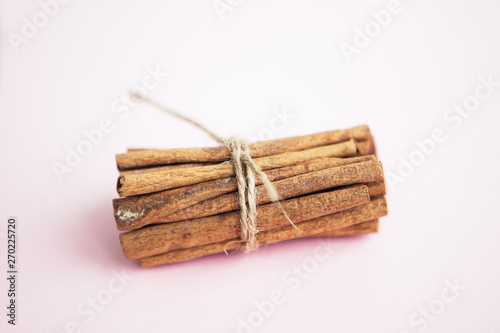 Set of cinnamon sticks on pink background