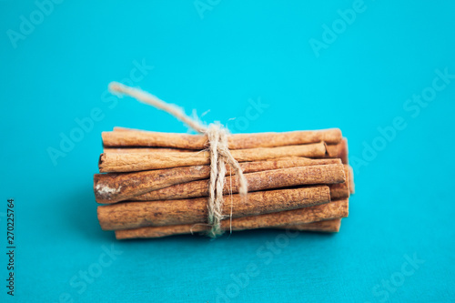Set of cinnamon sticks on turquois background