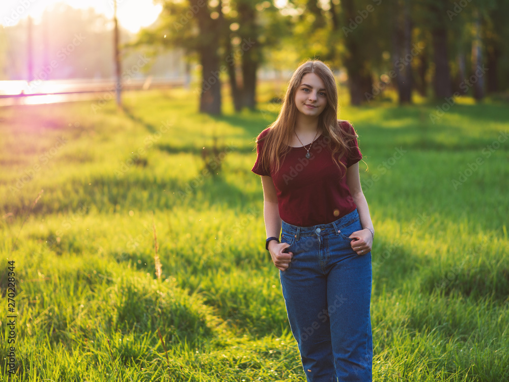 portrait of an attractive girl in stylish clothes at sunset in the Park portrait of an attractive girl in stylish clothes at sunset in the Park