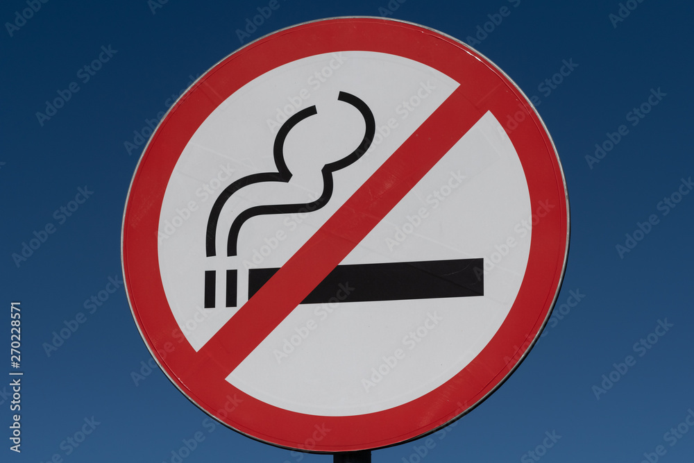 Round no Smoking sign on blue sky background Round no Smoking sign on blue sky background