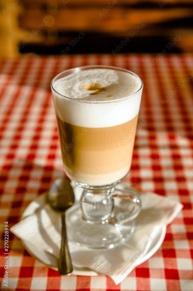 A Cup of coffee latte is on the table in the cafe A Cup of coffee latte is on the table in the cafe