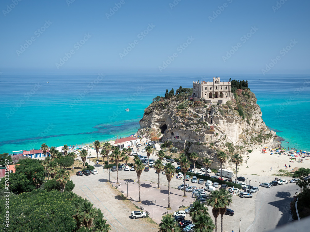Aerial view of the beach of Tropea and its Monastery on top of the island. Tropea is  the amazing seaside place in Calabria, Italy. The shot is taken during a beautiful sunny summer day