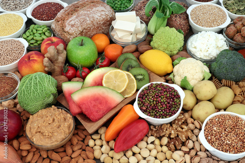 Large vegan health food selection with fruit, vegetables, bean curd, legumes, nuts, pasta, cereals, bread, grains, almond yoghurt & peanut butter. High in antioxidants, omega 3, protein & fibre.