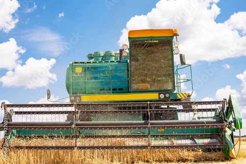combine harvester working on a wheat field.