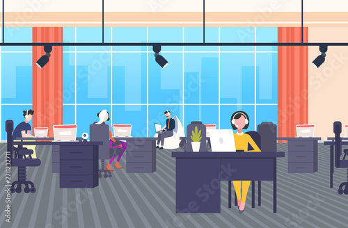 coworkers in headset operators sitting at workplace desks call center concept co-working open space modern office interior flat horizontal banner full length