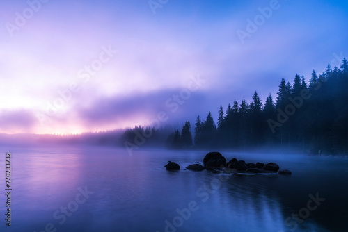 Stunning image of the foggy lake Shiroka poliana in Rhodope mountain, Bulgaria, Europe. Dramatic morning sunrise scene. 