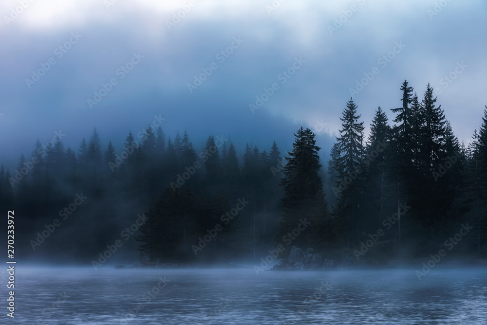 Stunning image of the foggy lake Shiroka poliana in Rhodope mountain, Bulgaria, Europe. Dramatic evening sunset scene. Stunning image of the foggy lake Shiroka poliana in Rhodope mountain, Bulgaria, Europe. Dramatic evening sunset scene.