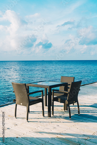 empty outdoor patio deck and chair with blue ocean in Maldives