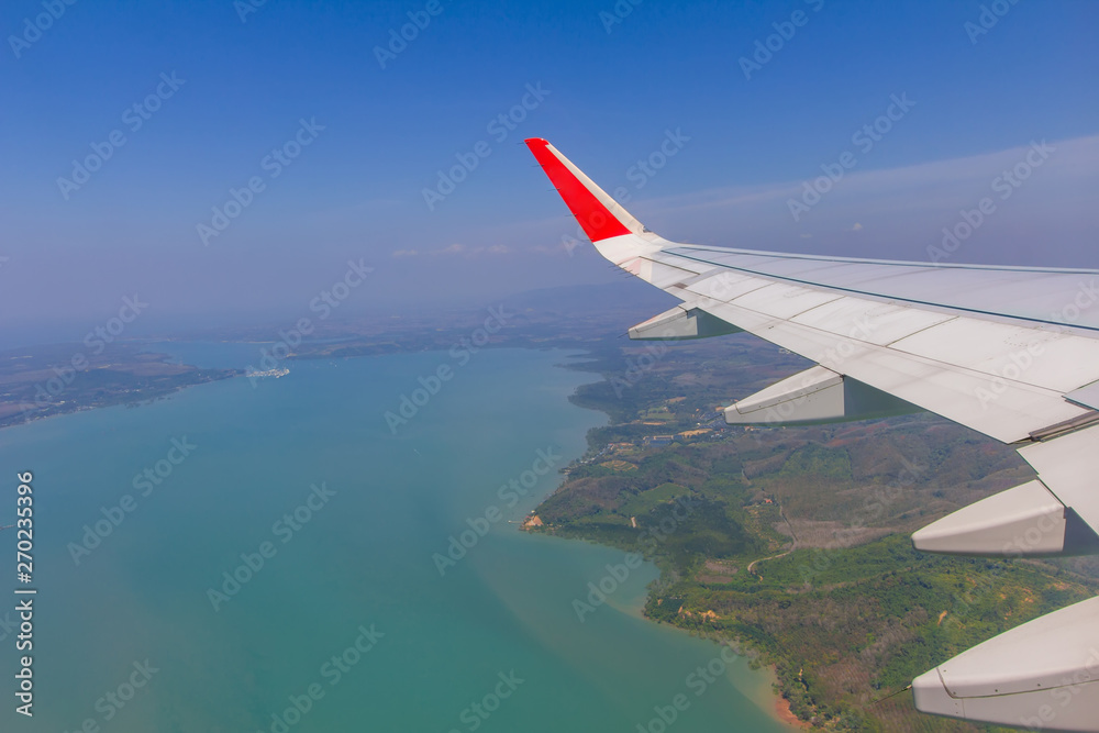 Sky wings and white clouds flying over Phuket, Thailand Sky wings and white clouds flying over Phuket, Thailand